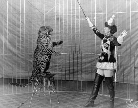 1200px-Female_animal_trainer_and_leopard,_c1906